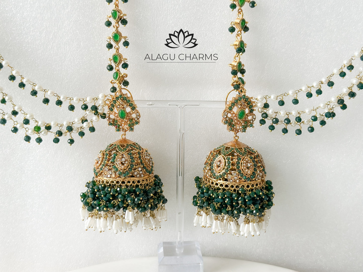Delicate Pakistani-style gold-tone jhumka earrings featuring intricate filigree work and a matching ear chain, elegantly draped for a traditional and ornate bridal look. Pakistani jhumka