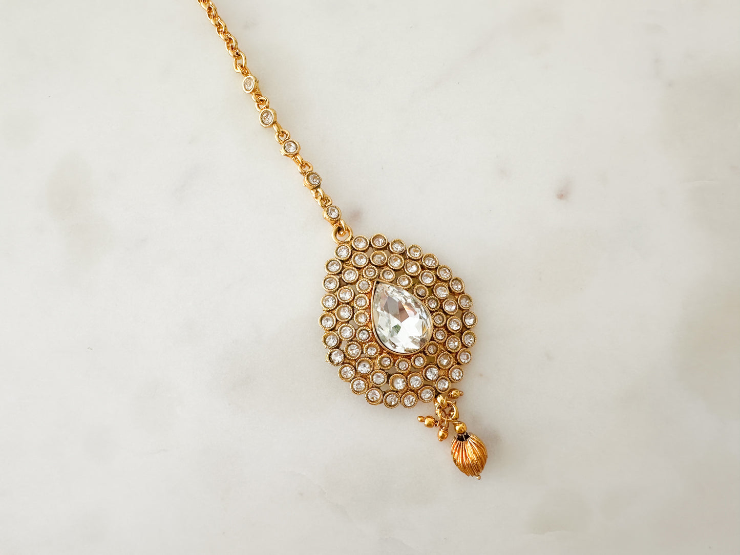 Gold tikka with clear stones