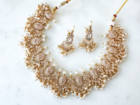 Narthana- Gold necklace set with clear stones