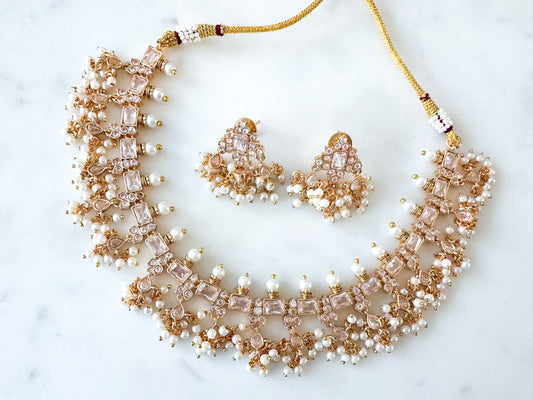 Nayana- Gold necklace set with clear stones